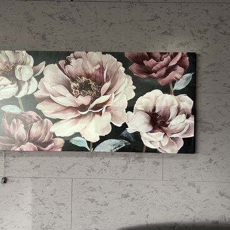 Ein langes Bild von 5 Blumen hängt an einer grauen Wand